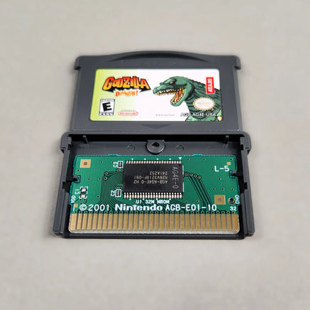Godzilla Domination! for Game Boy Advance - Open cartridge view showing the authentic PCB board with genuine Nintendo branding, very good condition