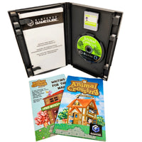 Nintendo GameCube Animal Crossing game case opened to show the game disc, manual, and instruction booklet on a white background.