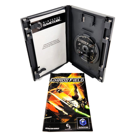 Nintendo GameCube Chaos Field game case opened to show the disc tray and insert card, with the instruction booklet placed in front on a white background.