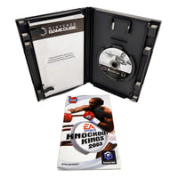 Nintendo GameCube game case for 'Knockout Kings 2003' shown open with the game disc inside, alongside the instruction booklet in front on a white background.