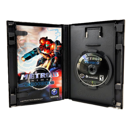 Nintendo GameCube Metroid Prime 2: Echoes game case opened to show the instruction booklet on the left and the game disc on the right, photographed on a white background.