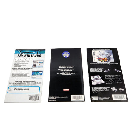 Rear side view of three printed Metroid Prime 2 Echoes items displayed side by side on a white background, including a pamphlet, an instruction booklet, and an advertisement featuring Metroid Prime Hunters artwork and branding.