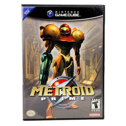 Nintendo GameCube Metroid Prime game case featuring Samus in a gold and red suit with green arm armor, shown on a plain white background.