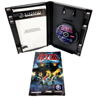 Nintendo GameCube 'Monster House' game package shown open, with the black plastic case containing a game disc, a printed instruction booklet inside the case on a white background.