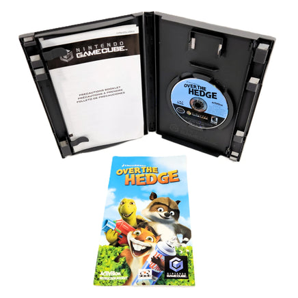 Nintendo GameCube 'Over the Hedge' game case opened to show the disc inside, with the game's instruction booklet placed in front on a white background.