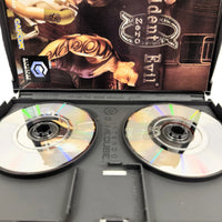 Nintendo GameCube game case for Resident Evil Zero, showing the open plastic case with two discs showing scratch free detail and the printed instruction manual art behind them.