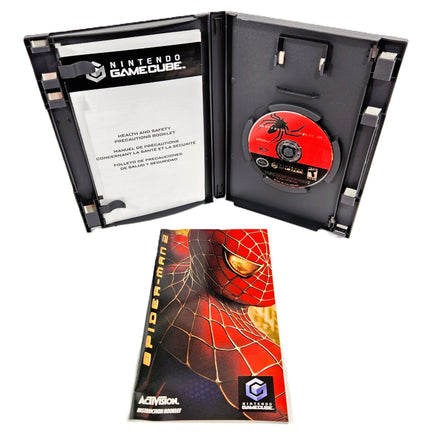 Nintendo GameCube Spider-Man 2 game case shown open with the game disc inside, plus the instruction manual placed below on a white background.