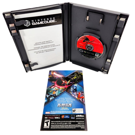 Nintendo GameCube Spider-Man 2 game case shown open with the game disc inside, plus the instruction manual, showing the rear view, placed below on a white background.