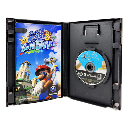 Nintendo GameCube game case for Super Mario Sunshine, shown open with the game instruction manual on the left and the disc on the right against a white background.