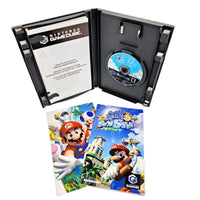 Super Mario Sunshine for Nintendo GameCube, shown with its black plastic game case open, containing the game disc, alongside instruction booklet on a white background.
