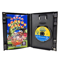 Super Monkey Ball for Nintendo GameCube open game case showing the game instruction manual on the left and a yellow-and-blue game disc on the right, photographed against a plain white background.