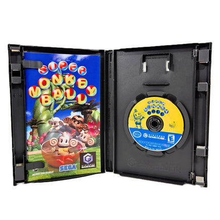 Super Monkey Ball for Nintendo GameCube open game case showing the game instruction manual on the left and a yellow-and-blue game disc on the right, photographed against a plain white background.