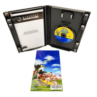 Nintendo GameCube 'Super Monkey Ball' game open, with the game case containing a yellow-and-blue game disc, a printed instruction booklet showing the back side