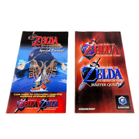 Two Nintendo GameCube instruction booklet covers for The Legend of Zelda: Ocarina of Time and Master Quest games, one featuring a special preview cover and the other an instruction booklet cover, displayed side-by-side on a white background.
