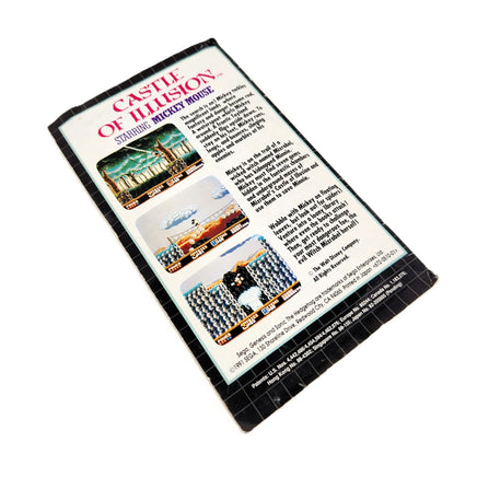 Rear view of Sonic the Hedgehog instruction manual for the Genesis console, featuring an advertisement for Castle of Illusion Starring Mickey Mouse game, photographed on a plain white background.