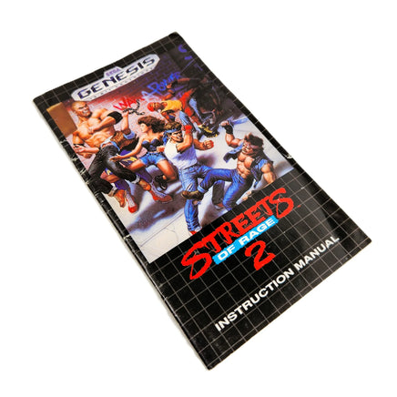 A vintage Sega Genesis instruction manual for the game Streets of Rage 2, shown at an angle on a plain white background.