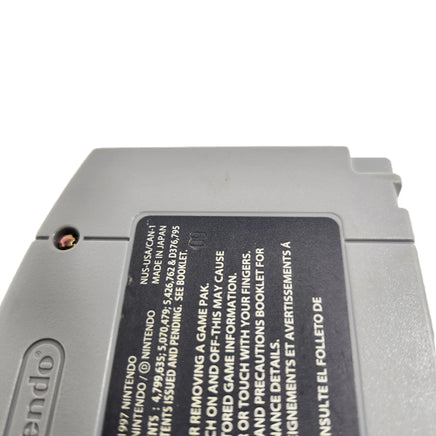 Close-up of the back of a gray Nintendo game cartridge with a black label showing printed text and warning information.