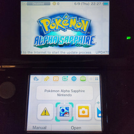 A Nintendo DS handheld console showing the Pokémon Alpha Sapphire game screen on the upper display and the device's interface on the lower screen, photographed against a dark background.