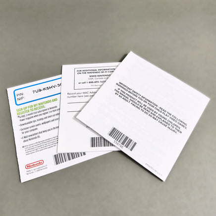 Mario Kart DS for Nintendo DS - Rear view of Nintendo DS game packaging materials on a neutral gray background, including a white Wi-Fi booklet, a white product card, and a green promotional insert featuring Bowser and the text 'Nintendo Power'.