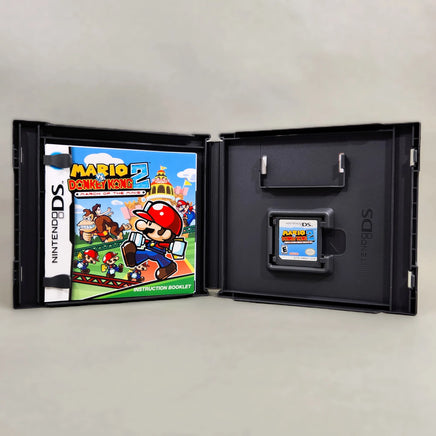 Mario vs. Donkey Kong 2: March of the Minis for Nintendo DS - Open case displaying contents, good condition