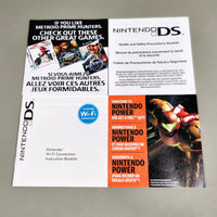 Front view of Nintendo DS printed pamphlets laid flat on a light gray surface: a health and safety booklet, a Wi-Fi connection booklet, and a promotional insert featuring the Nintendo Power logo and a Metroid Prime Samus illustration.