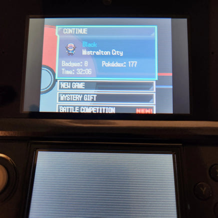 A close-up of a Nintendo 3DS handheld game console screen showing the game menu, with a Pokémon badge selection pop-up for Black and Mistralton City visible on the top screen.