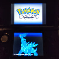 A Nintendo DS handheld game console displaying the Pokémon Diamond Version game menu, with the Pokémon logo on the top screen and a glowing blue Groudon character on the bottom screen.