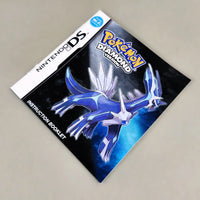 Nintendo DS Pokémon Diamond Version instruction booklet featuring a blue and white illustration of Paldean Gyarados on a dark background, photographed on a light gray surface.
