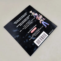 Rear view of Nintendo DS Pokémon Diamond Version instruction booklet featuring game character illustrations on a dark background, photographed on a light gray surface.