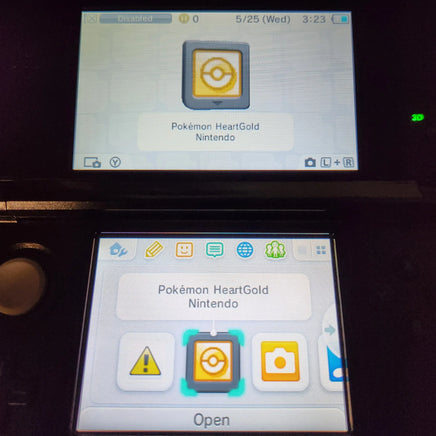 A close-up of a Nintendo 3DS handheld console screen showing the Pokémon HeartGold app interface, with the Pokémon HeartGold icon displayed on the screen and the game card selected in the menu.