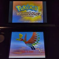 A retro Nintendo DS handheld game console showing the Pokémon HeartGold Version game menu, with the Pokémon logo on the top screen and a flying bird character on the bottom screen with 'TOUCH TO START' text.