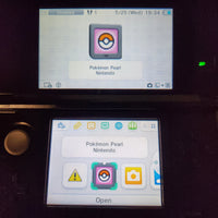 A close-up of a Nintendo DS handheld console showing the Pokémon Pearl game app tile on both the top screen and the lower screen interface.