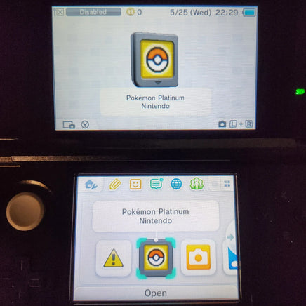 Nintendo DS device showing the Pokémon Platinum app interface on the screens, with one device displaying the app cover and the other showing app icons including a Pokémon badge.