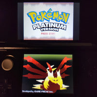 A Nintendo DS handheld console showing the Pokémon Platinum Version game screen, with the Pokémon logo on the upper display and a red-and-yellow Eevee-style character on the lower screen.