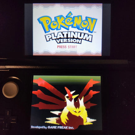 A Nintendo DS handheld console showing the Pokémon Platinum Version game screen, with the Pokémon logo on the upper display and a red-and-yellow Eevee-style character on the lower screen.