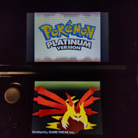 Nintendo 3DS handheld console displaying the Pokémon Platinum Version game screen, with the Pokémon logo on the top screen and a red and yellow Phoenix-like Pokémon illustration on the bottom screen.