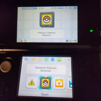 A Nintendo 3DS handheld console with two screens, showing the Pokémon Platinum Version Nintendo game app on the touch displays against a dark background.