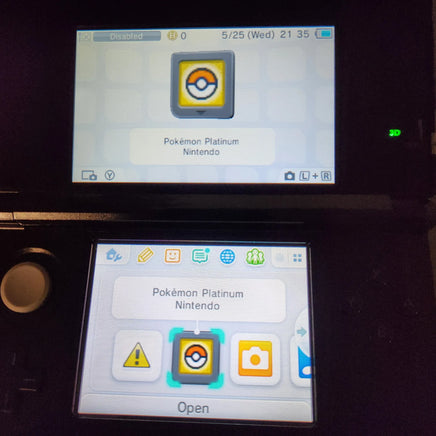 A Nintendo 3DS handheld console with two screens, showing the Pokémon Platinum Version Nintendo game app on the touch displays against a dark background.
