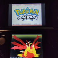 A Nintendo 3DS game console displaying the Pokémon Platinum Version game menu, with the Pokémon logo on the top screen and a pixelated red and yellow character on the bottom screen.