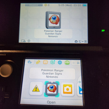 A close-up of a Nintendo 3DS handheld console showing the Pokémon Ranger Guardian Signs icon on the screen, with the top screen displaying the selected icon and the bottom screen showing the open menu.