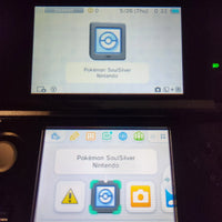 A close-up of a Nintendo 3DS handheld console screen showing the Pokémon SoulSilver app interface, with the Pokémon and Nintendo branding visible on the display.