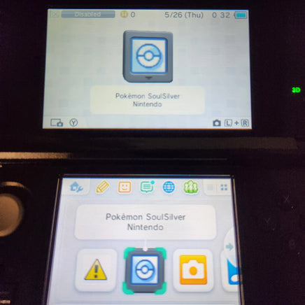 A close-up of a Nintendo 3DS handheld console screen showing the Pokémon SoulSilver app interface, with the Pokémon and Nintendo branding visible on the display.