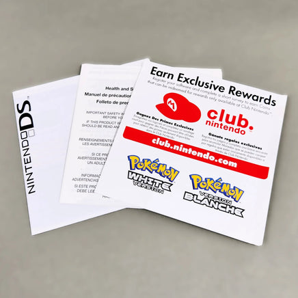 A set of Nintendo Club Nintendo promotional inserts, featuring the 'Earn Exclusive Rewards' card, a red Nintendo logo card, and a white Nintendo DS manual on a neutral gray background.