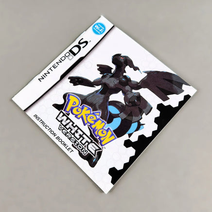 Nintendo DS Pokémon White Version instruction booklet, featuring a white cover with black, blue, and yellow graphics, shown on a neutral gray background.