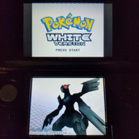 A Nintendo DS handheld game console showing the Pokémon White Version main menu, with a Pokémon displayed on the lower screen.
