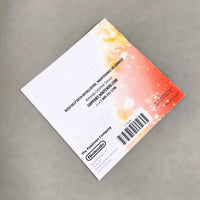 Rear view of a Nintendo DS instruction manual for Pokémon White Version 2, photographed on a neutral gray background.