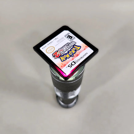 Pokémon White Version 2 for Nintendo DS - Pokémon DS game cartridge light test showing the characteristic crimson translucent appearance, very good condition