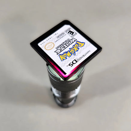 Pokémon White Version for Nintendo DS - Close-up view of translucent Pokémon DS cartridge with visible crimson red glow, very good condition, loose