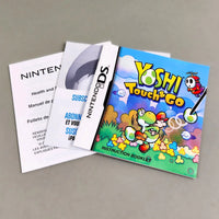 Yoshi Touch & Go for Nintendo DS - Official game manual with other paperwork and pamphlets fanned out on a gray background, like new condition