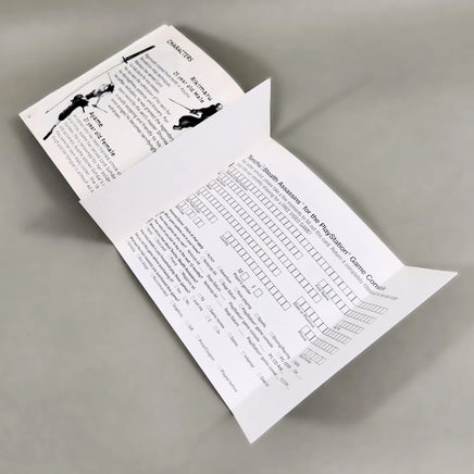 Tenchu: Stealth Assassins for PlayStation 1 - Interior view of open instruction manual showing registration card intact, very good condition